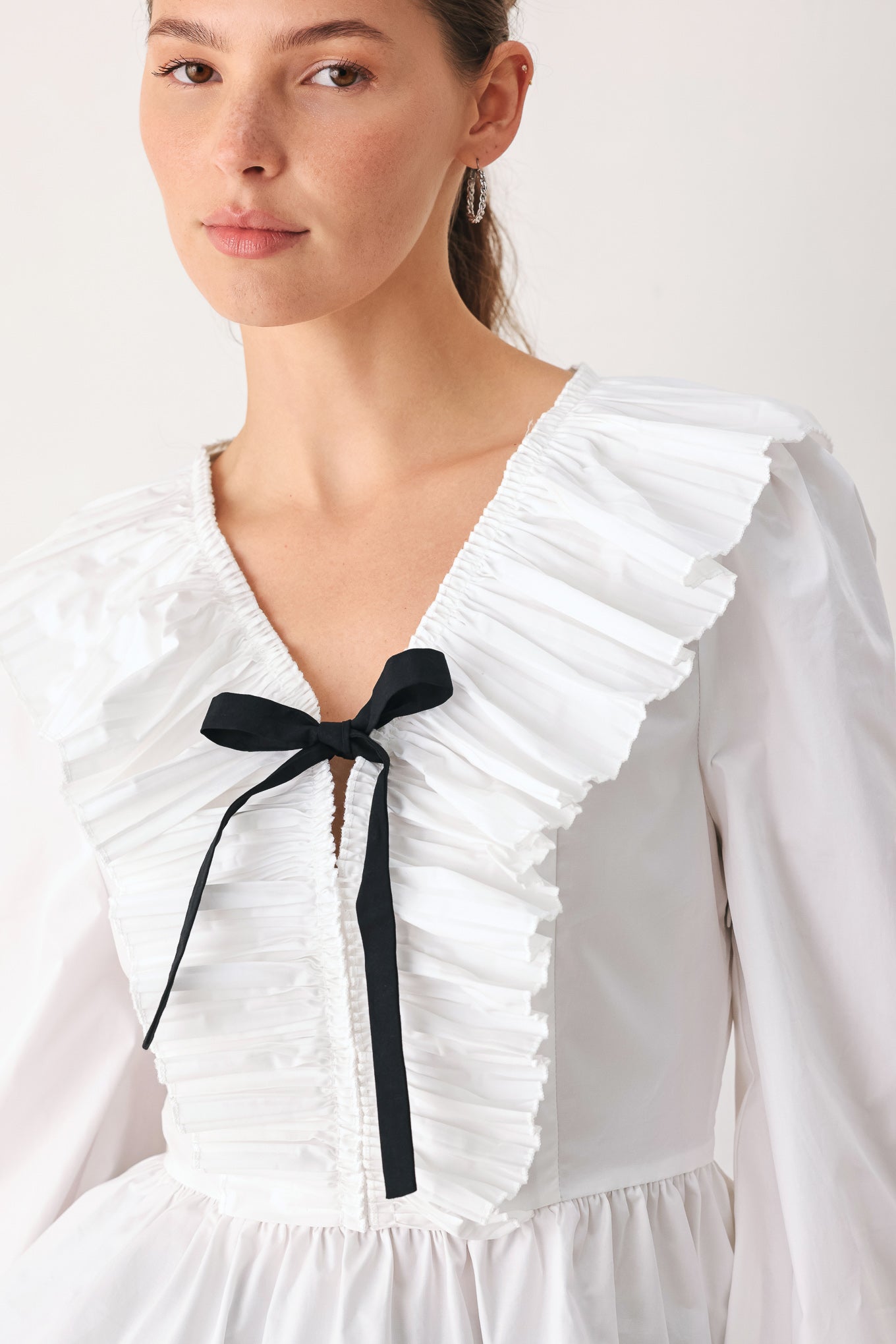 AMELIE PLEATED RUFFLE V-NECK WOVEN TOP