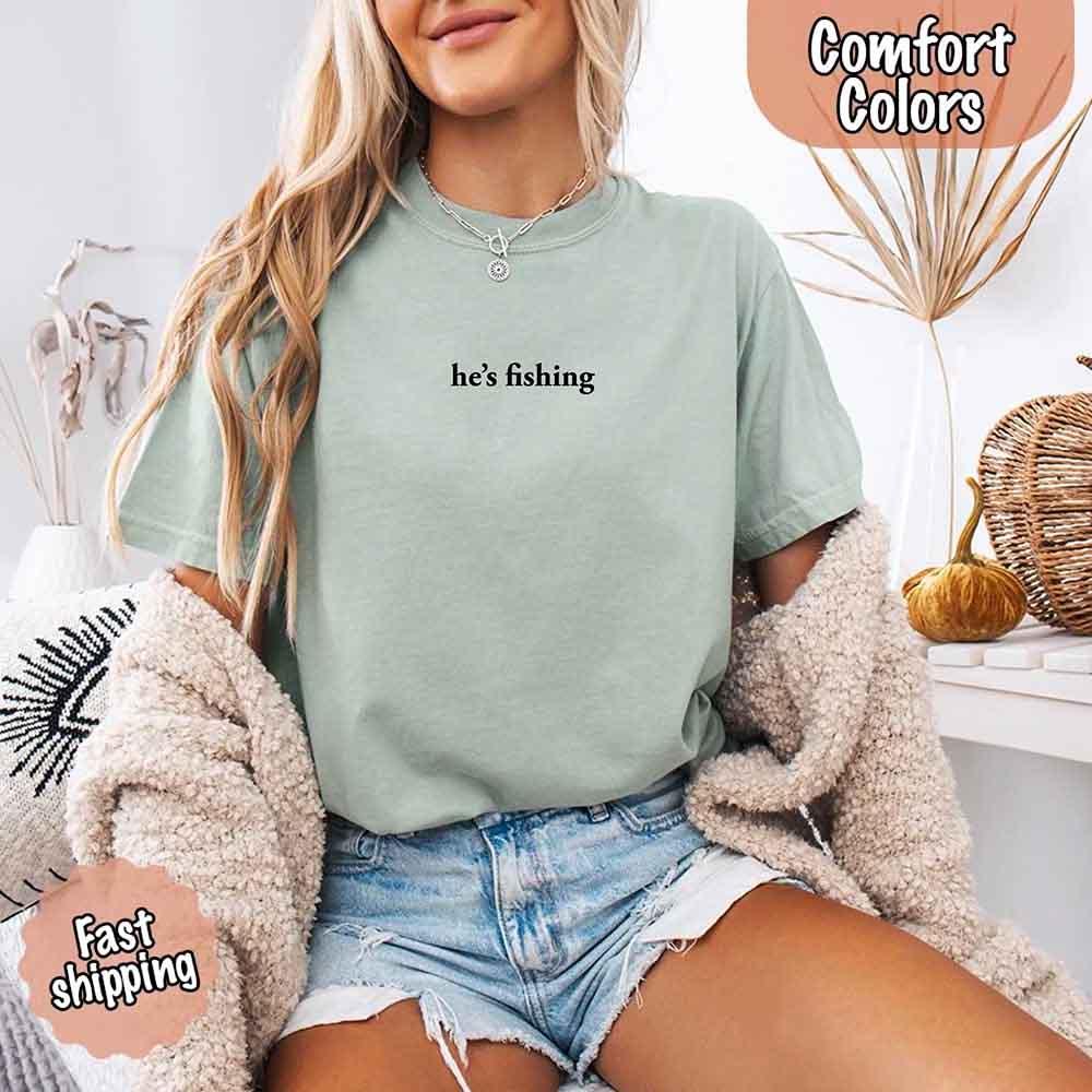 Adorb Custom Tees He's Fishing Comfort Colors Tee, showcasing the unique graphic design on this relaxed fit women's shirt.