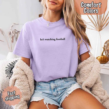 He’s Watching Football Tee - Comfort Colors Funny Shirt for Her
