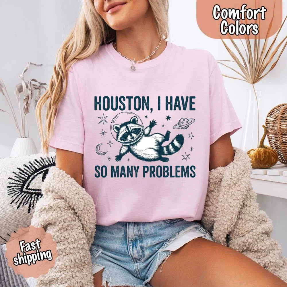 A group of friends wearing different colors of the Adorb Custom Tees funny raccoon space humor t-shirt.