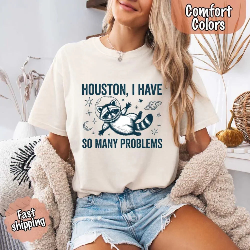 A person wearing the Adorb Custom Tees raccoon space humor t-shirt, showing its relaxed, comfortable fit.