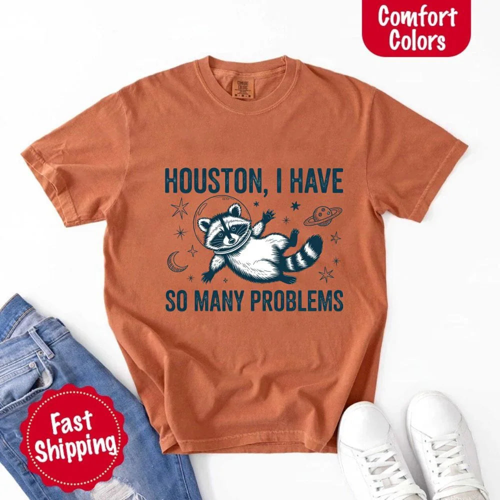 The Houston I Have So Many Problems raccoon t-shirt by Adorb Custom Tees, neatly folded to show its quality print.