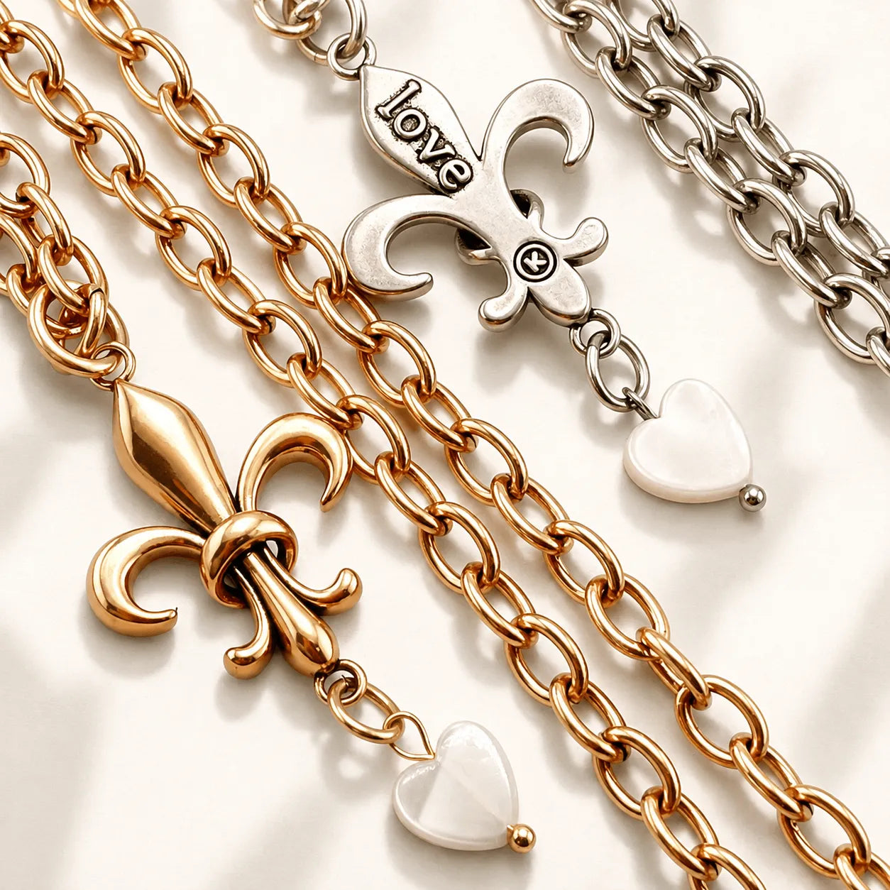 Katia Designs Love Fleur-de-Lis Essential Necklace, showcasing the elegant gold-tone pendant with a single pearl on a delicat