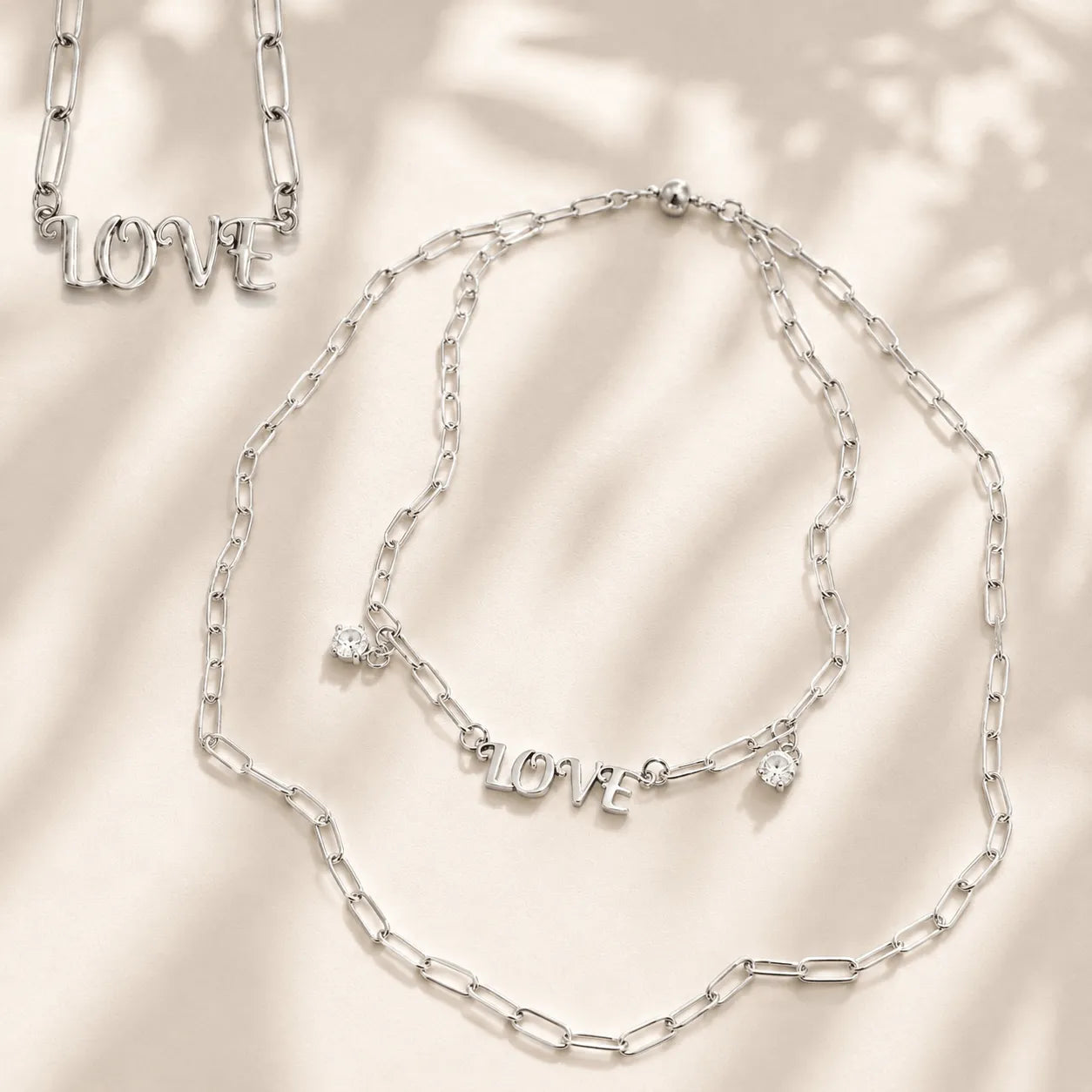 Katia Designs Love Long Chain Necklace draped gracefully, highlighting its length and how it complements various styles.