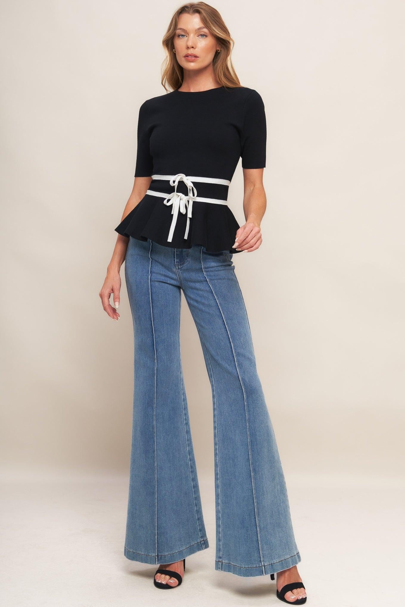 Flying Tomato SUNLIT GROVE BLACK SWEATER KNIT TOP, styled for a modern look, highlighting its relaxed yet refined aesthetic.