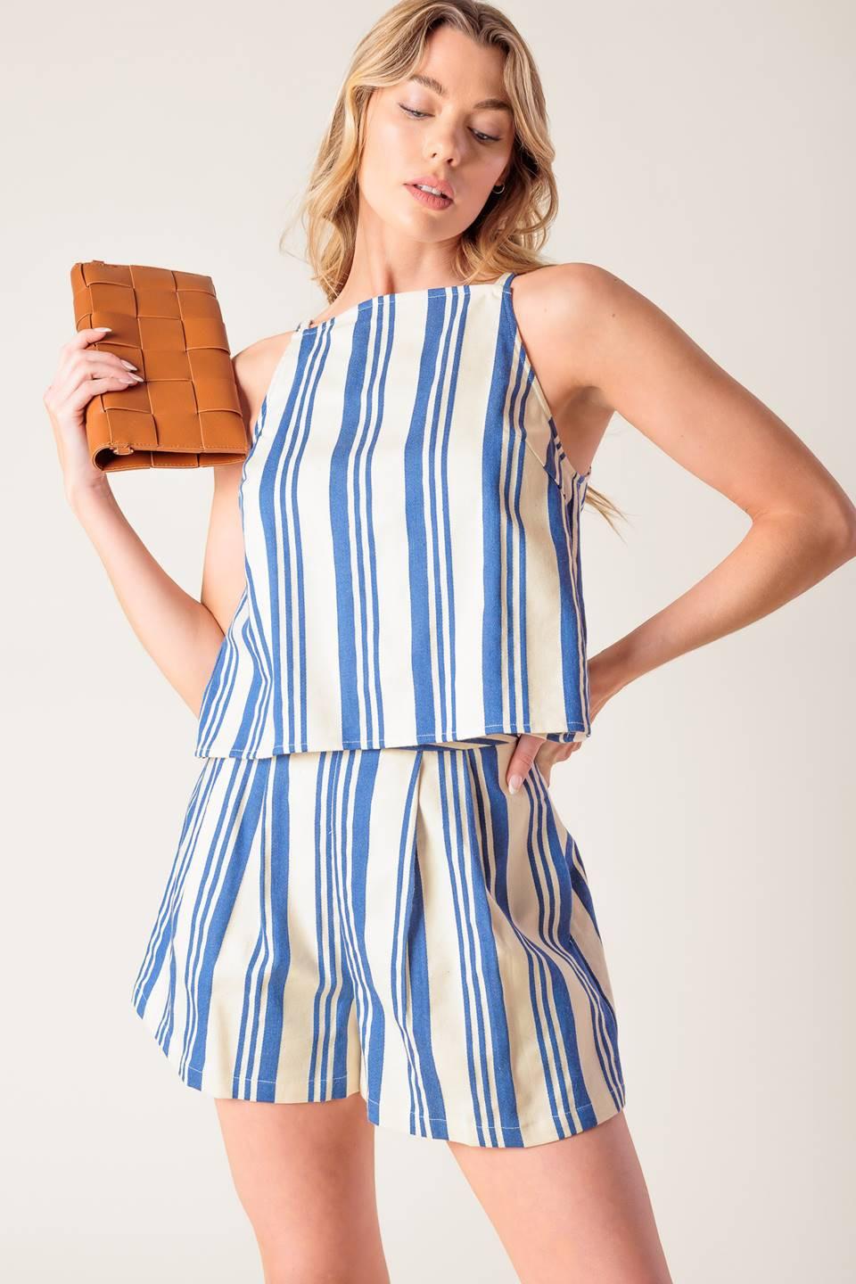 Flying Tomato AROUND THE WORLD WOVEN TOP, showcasing the flattering neckline and relaxed short sleeves for comfortable wear.