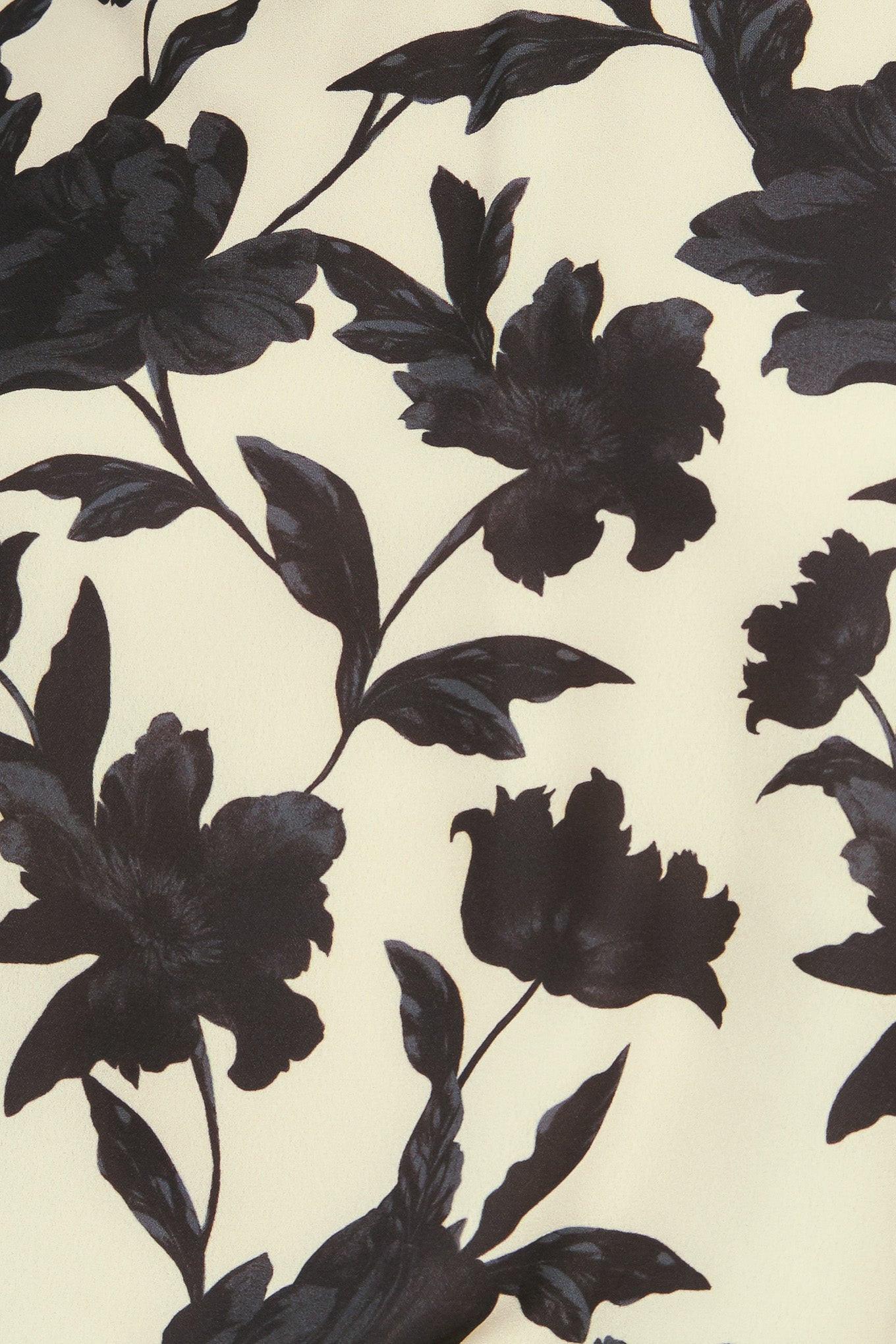 Close-up on the hemline of the Flying Tomato FREEDOM FLORAL STATEMENT WOVEN TOP, showcasing the fine stitching and quality of