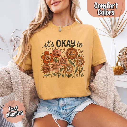 Adorb Custom Tees' It’s Okay Boho Floral Comfort Colors Tee in a soft, vintage-washed fabric with a wildflower graphic.