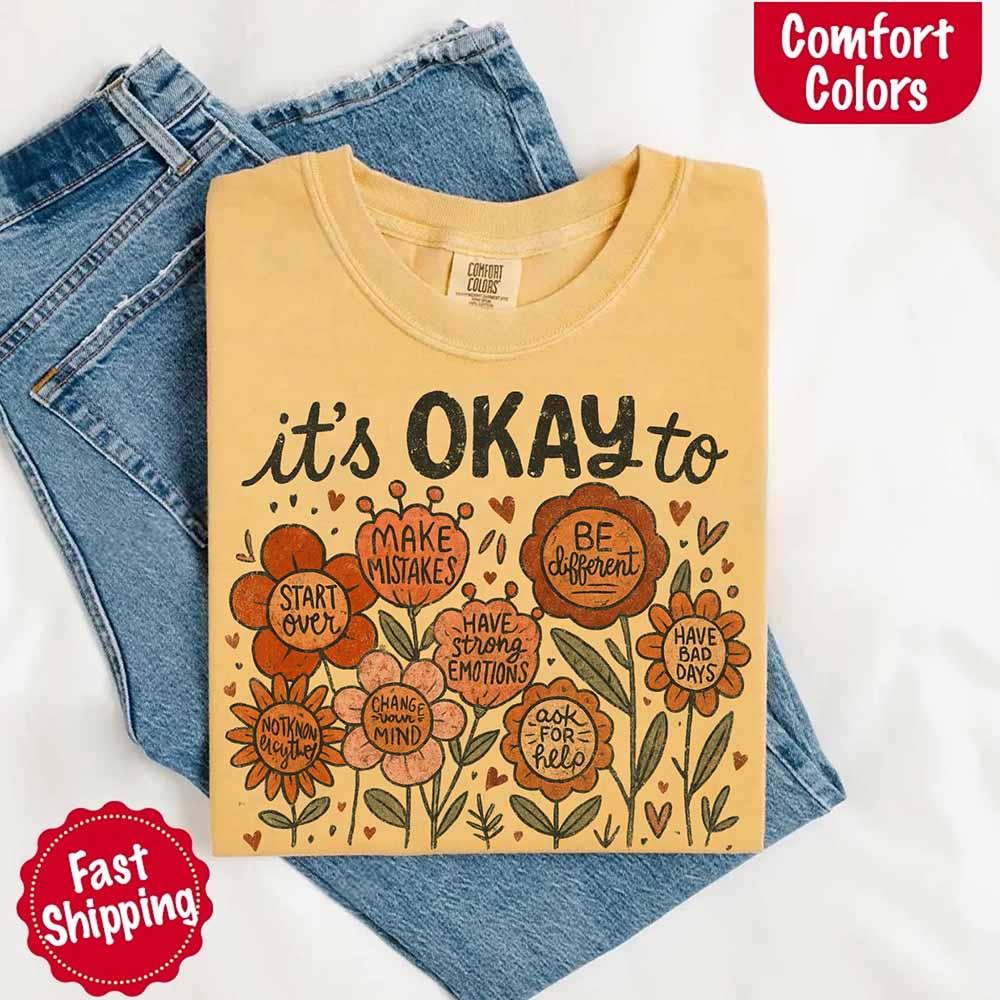 A woman wearing the Adorb Custom Tees' vintage wildflower shirt, styled for a casual, boho-inspired look outdoors.