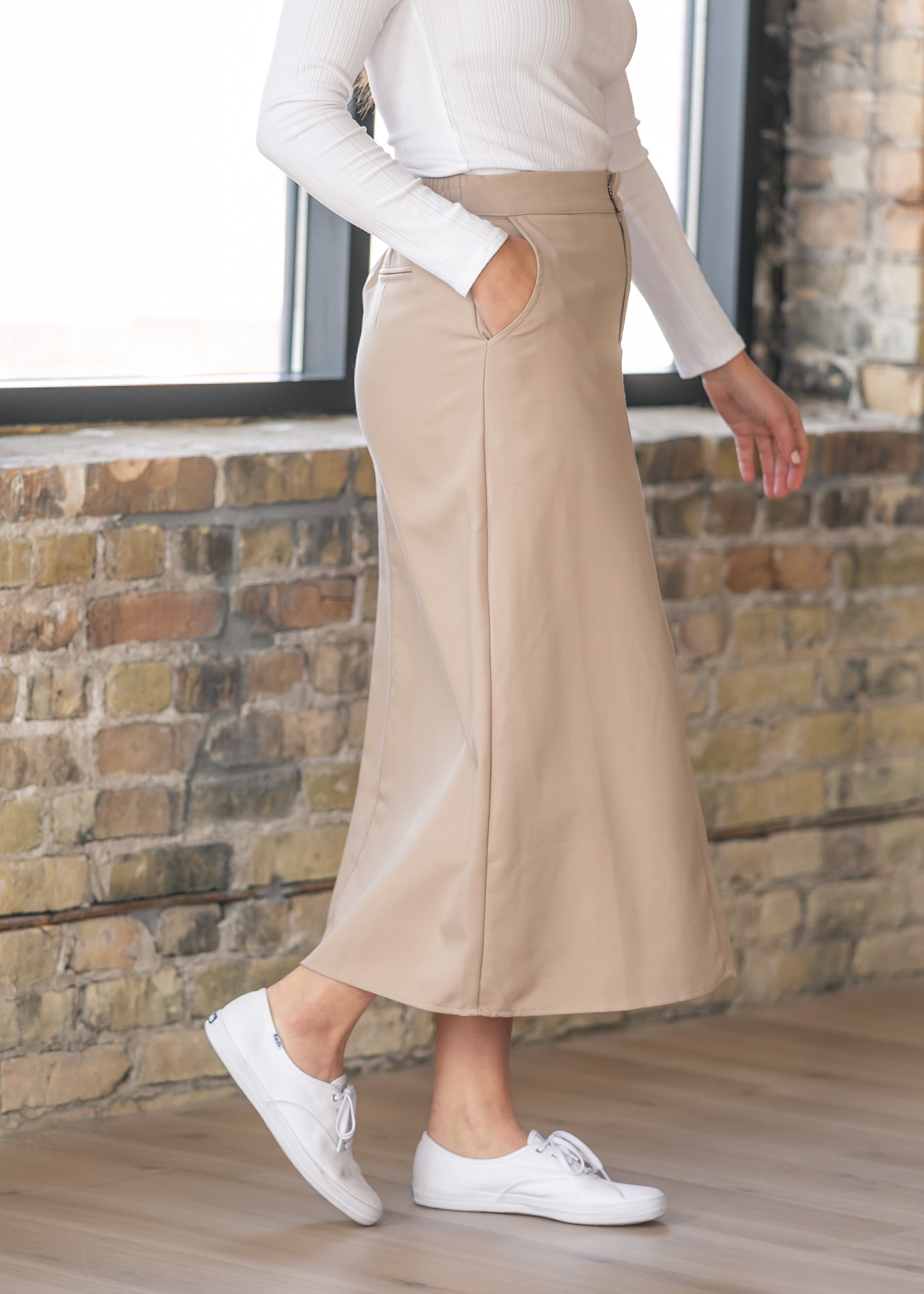 Inherit Co. Dylan Midi Trouser Skirt in motion, illustrating the graceful drape of its quality fabric and elegant midi length