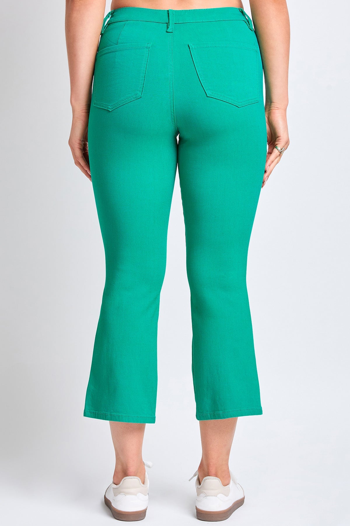 Model wearing YMI JEANS Women's Hyperstretch Cropped Kick Flare Pants, demonstrating their comfortable movement and modern fa