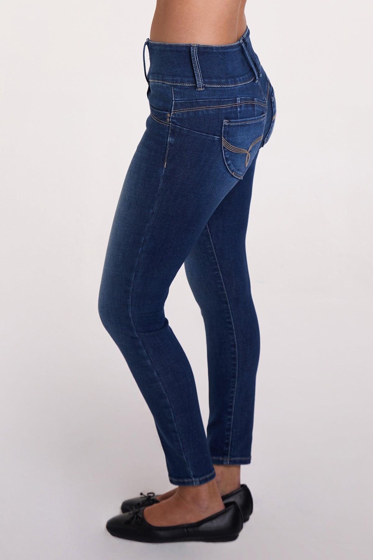 Side profile of the YMI JEANS Women's Luxe Mid Rise 3-Button WannaBettaButt Skinny Jeans, highlighting the slim fit.