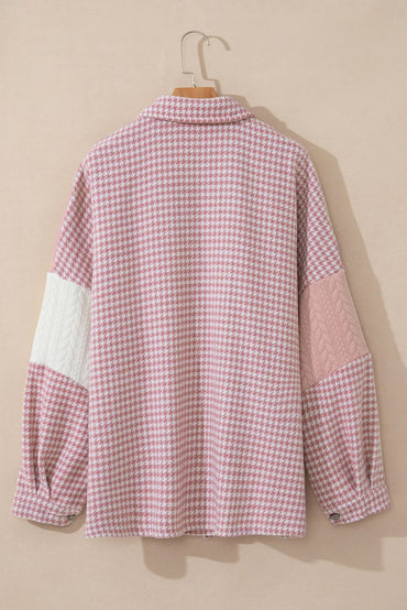 Pink houndstooth color contrast textured patchwork loose shacket hanging on a hanger.