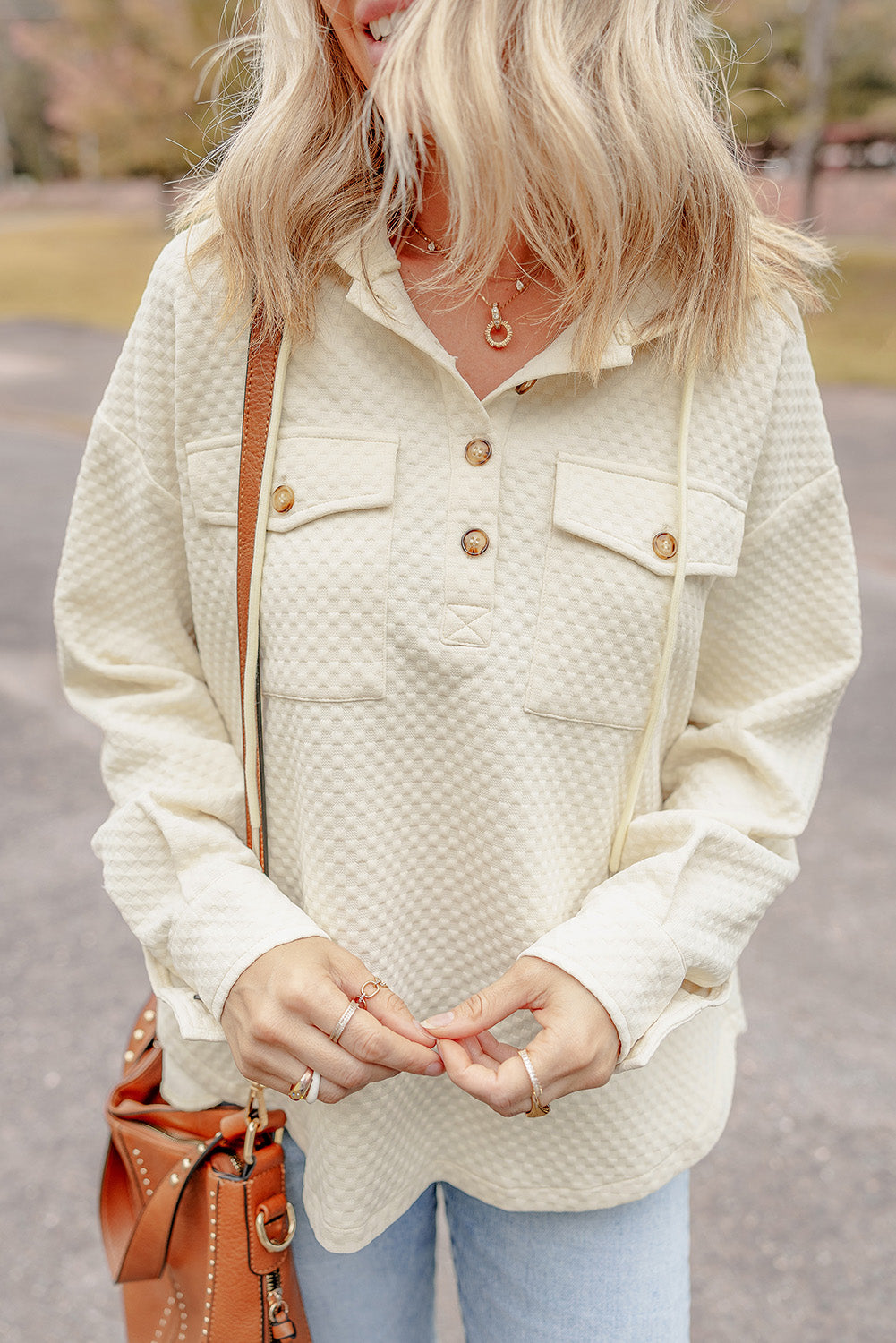 Chic apricot hoodie with buttoned neckline and functional pockets