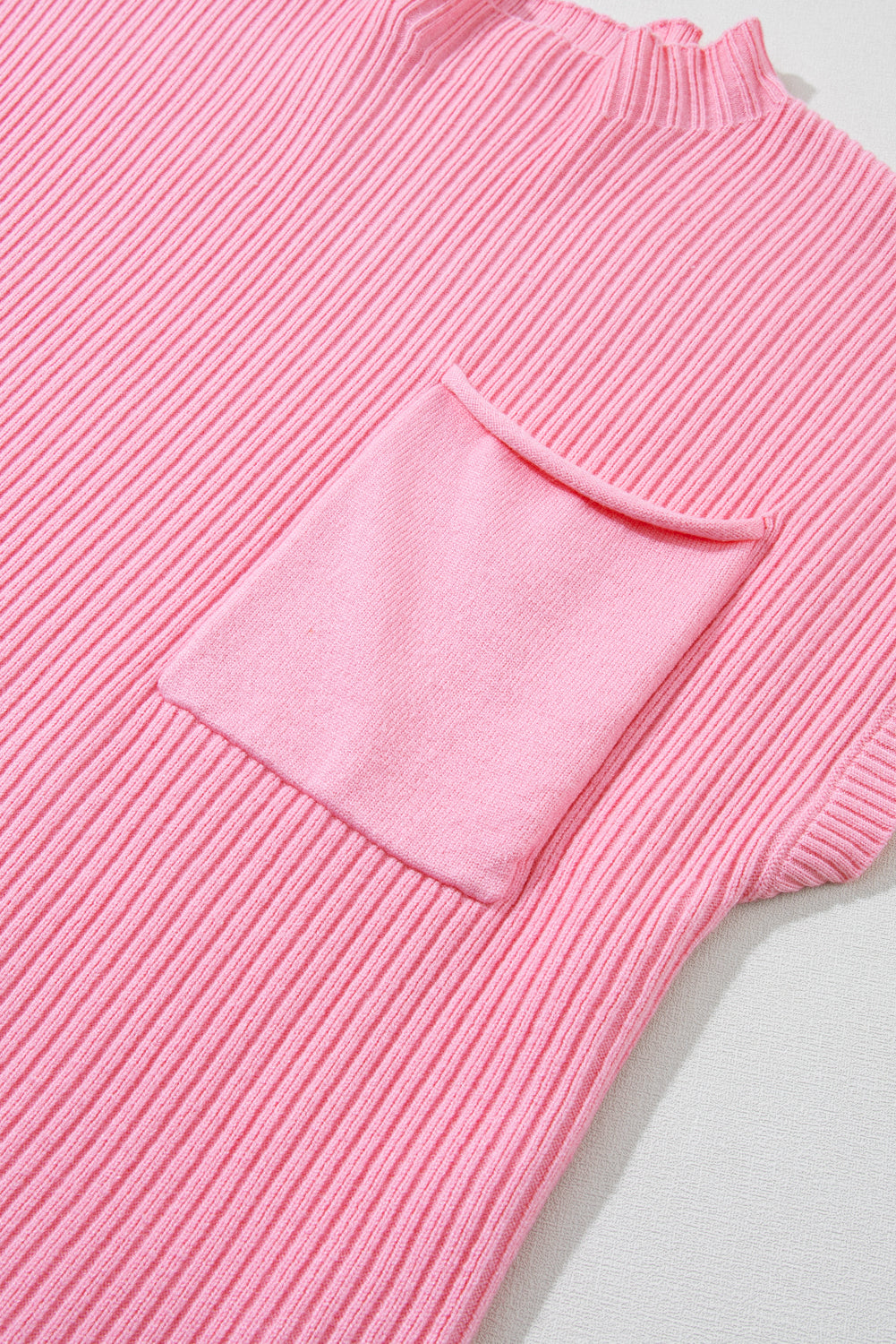 Cozy pink ribbed knit sweater with patch pocket and short sleeves