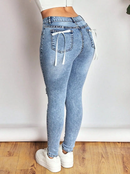 Bow Back Distressed Skinny Jeans