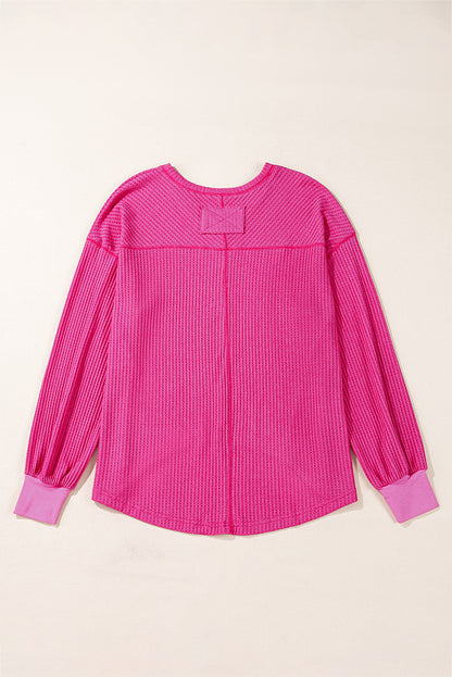 Chic bright pink waffle knit V-neck blouse with drop shoulders