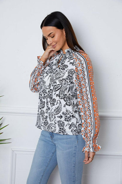 Tassel Tie Neck Printed Smocked Long Sleeve Blouse.