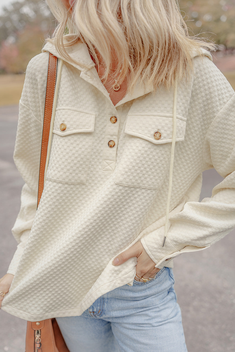 Chic apricot hoodie with buttoned neckline and functional pockets