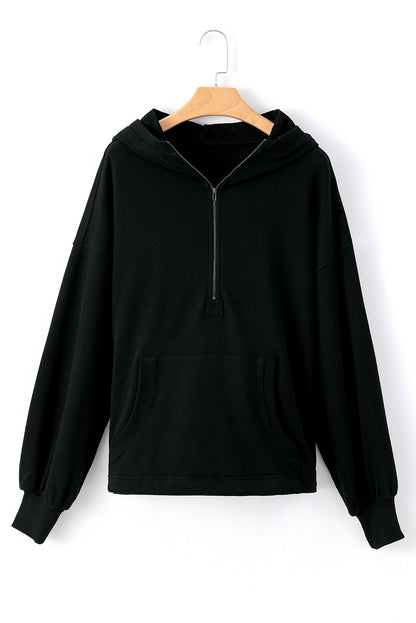 Cozy black oversized hoodie with kangaroo pocket and half zipper