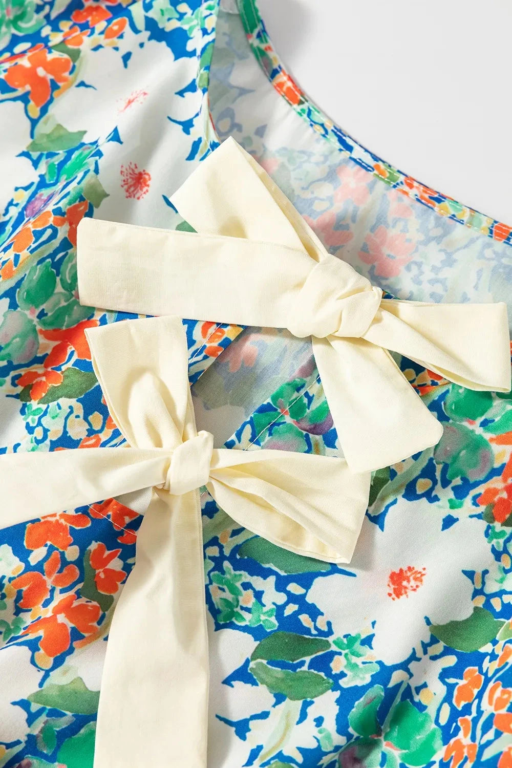 Floral Print Bow Applique Slit Sleeveless Peplum Blouse Simply Love