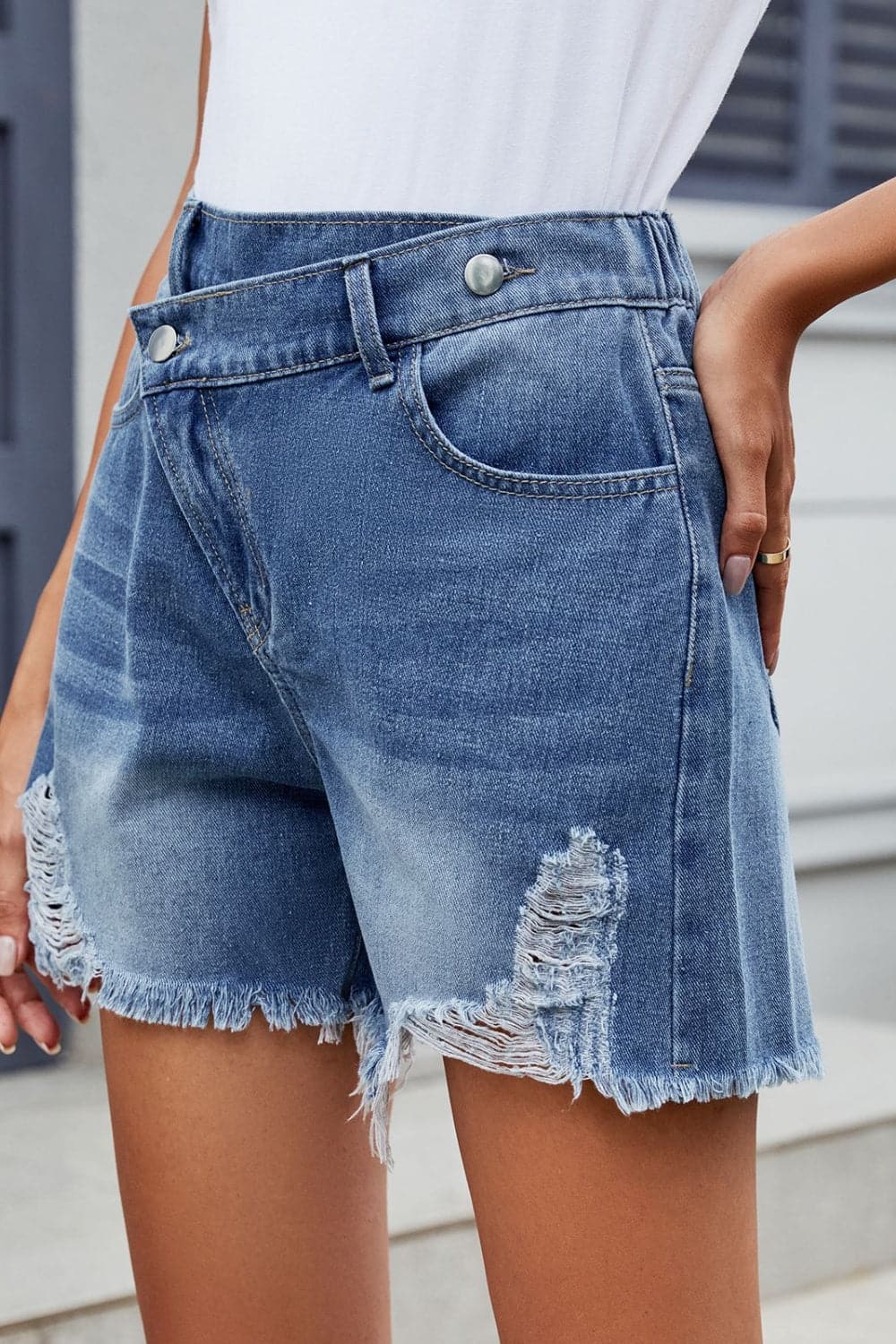 Distressed Raw Hem Asymmetric Waist Denim Shorts.