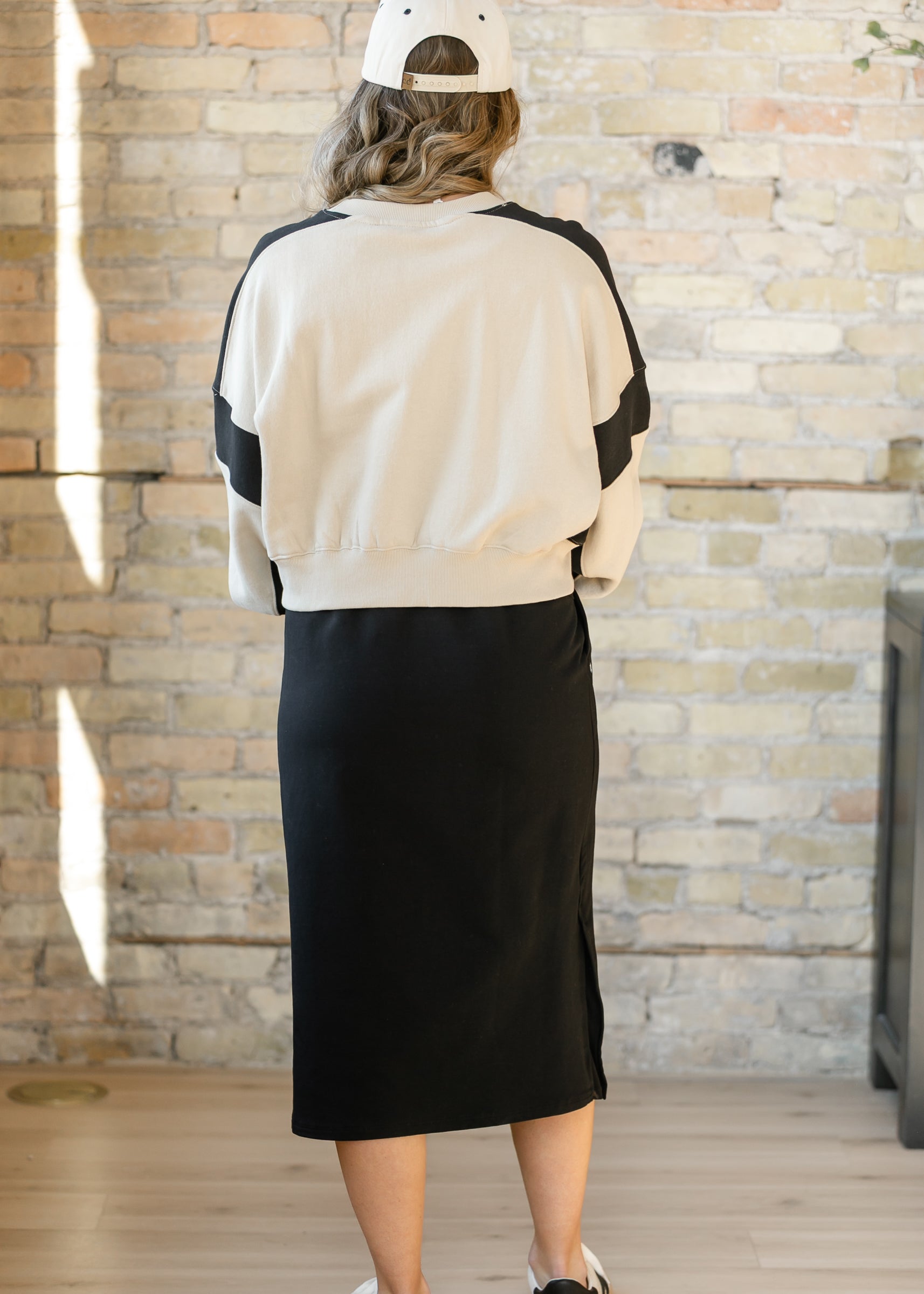 Model wearing the Inherit Co. Abbie Mesh Detail Knit Midi Skirt, styled for an elegant, modern women's fashion look.