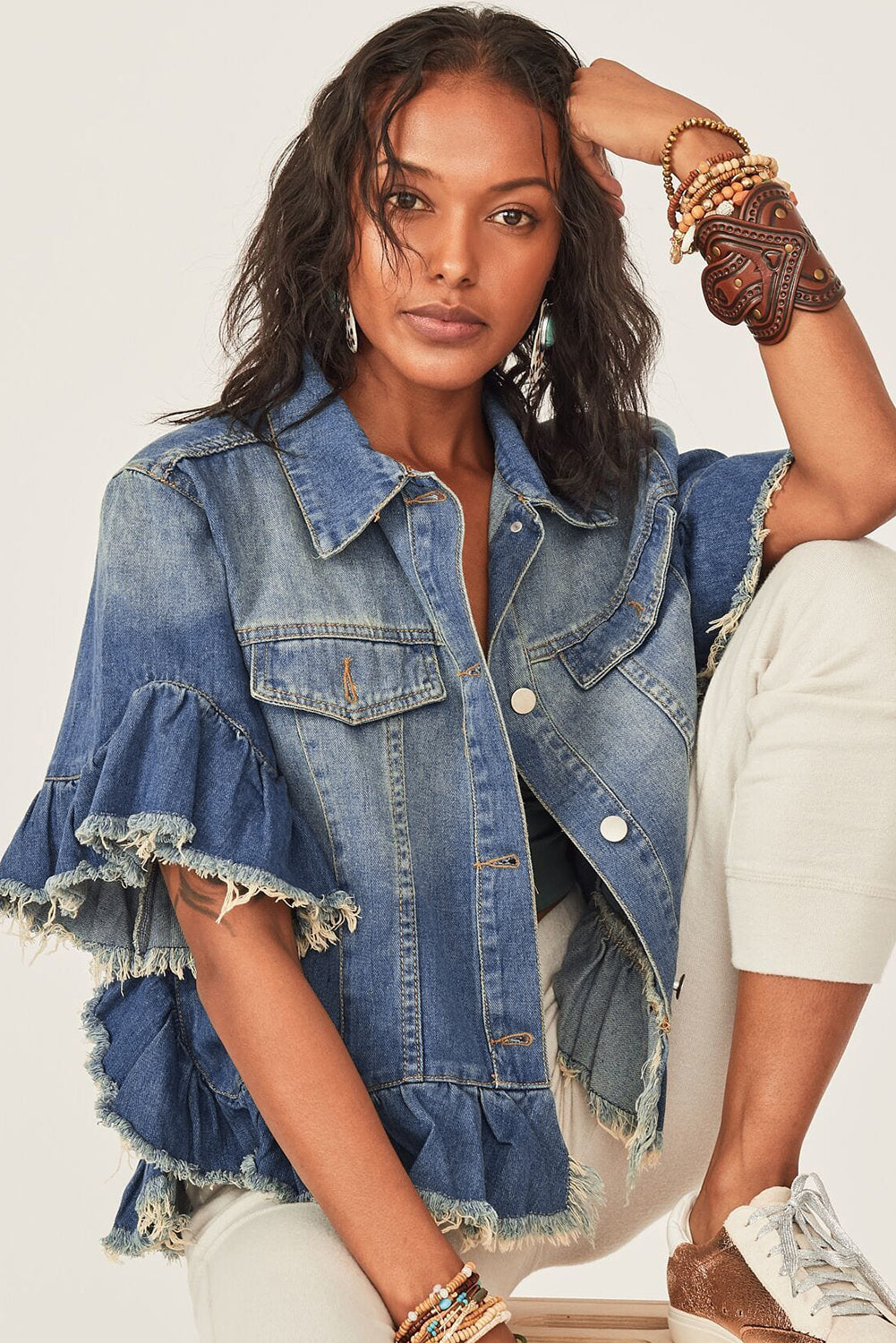 Peacock blue ruffled denim jacket with a raw edge detail