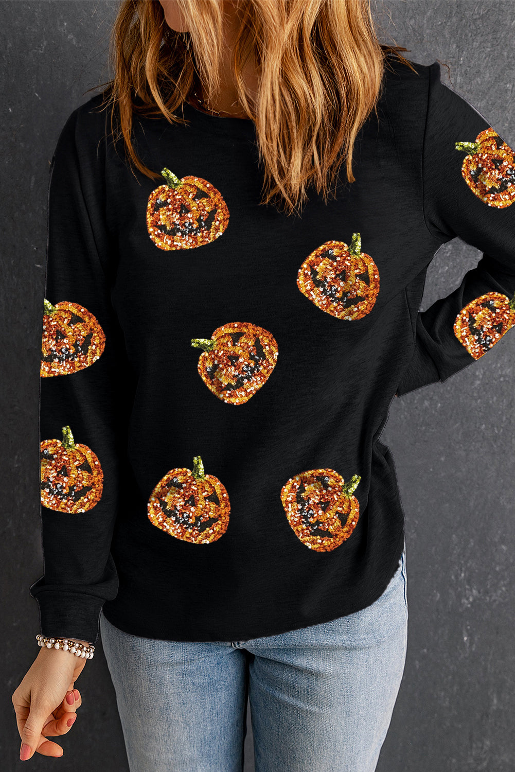 Sparkling pumpkin face pullover for a spooky Halloween look