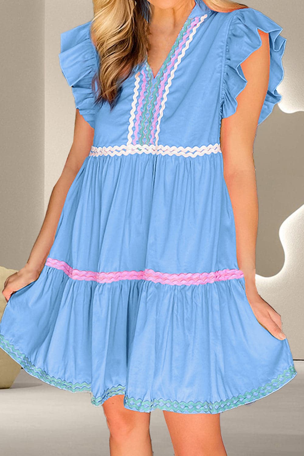 Ruffled notched cap sleeve mini dress in blue with delicate ruffles.