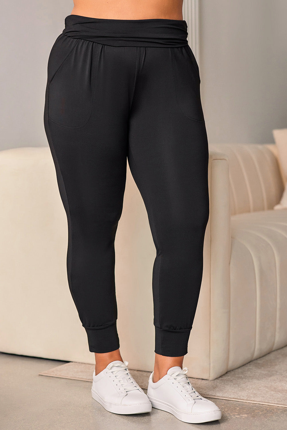 Stylish black high-waisted plus-size skinny trousers with pockets