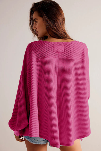 Chic bright pink waffle knit V-neck blouse with drop shoulders