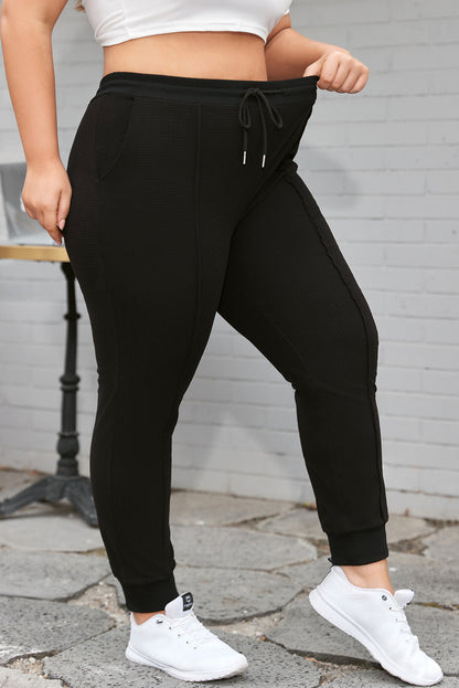 Trendy black plus size joggers with drawstring and textured design