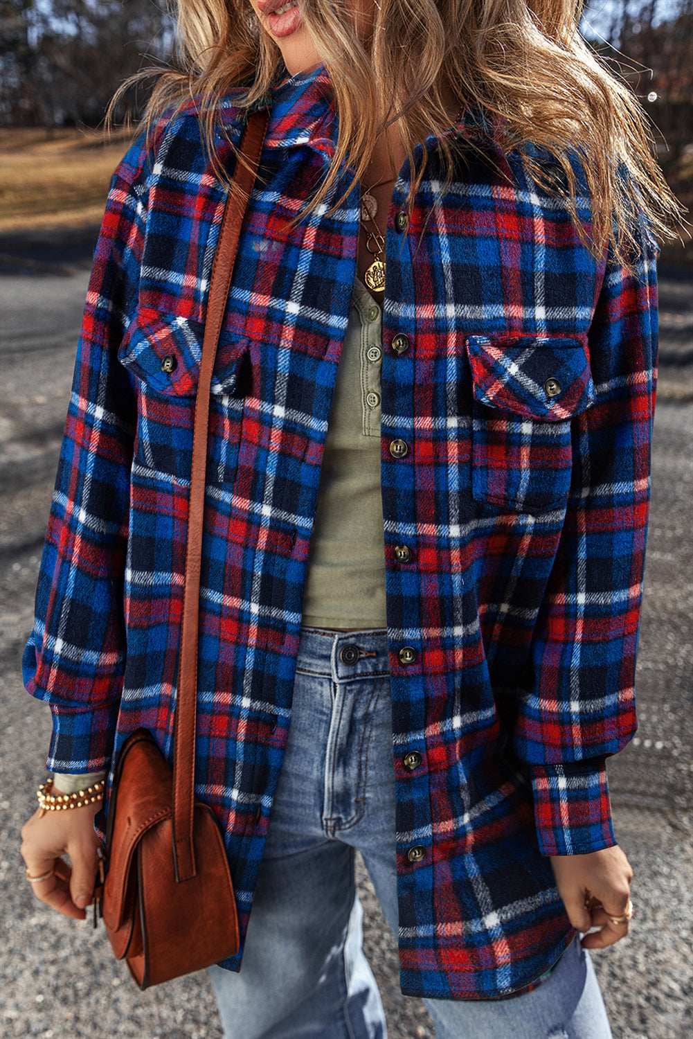 Navy plaid shacket with pockets, long sleeves, and button-up front.