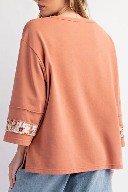 Floral round neck blouse with exposed seams and slits