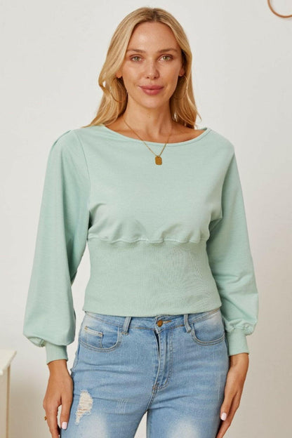 Boat neck blouse with elegant lantern sleeves in light green.