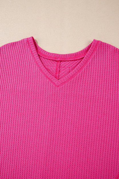 Chic bright pink waffle knit V-neck blouse with drop shoulders