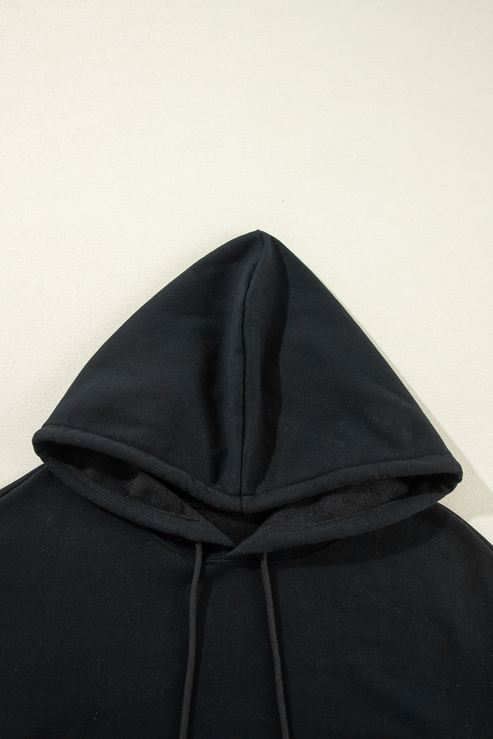 Cozy black fleece-lined hoodie with kangaroo pocket and drawstring design