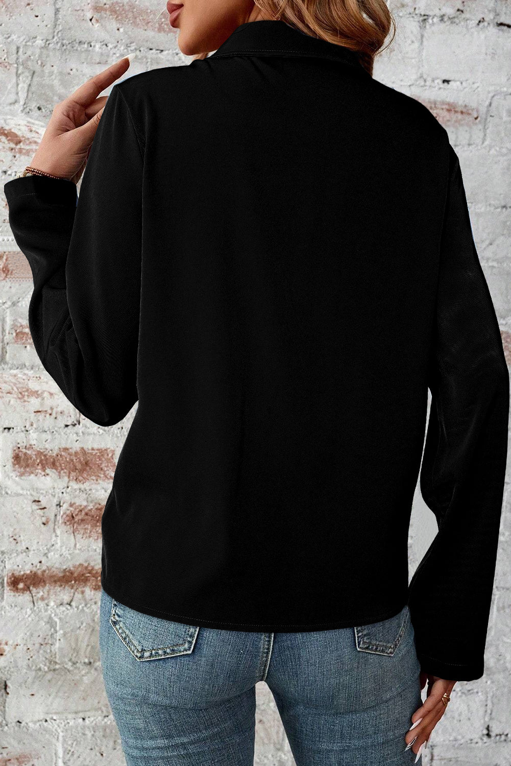 Sleek black zip-up jacket with tab sleeves and flap details