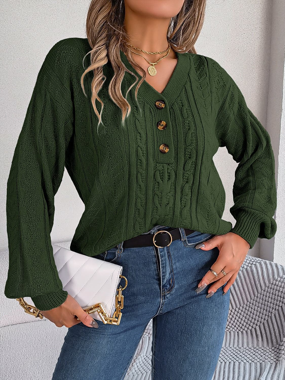 Chic cable-knit v-neck sweater with buttoned details