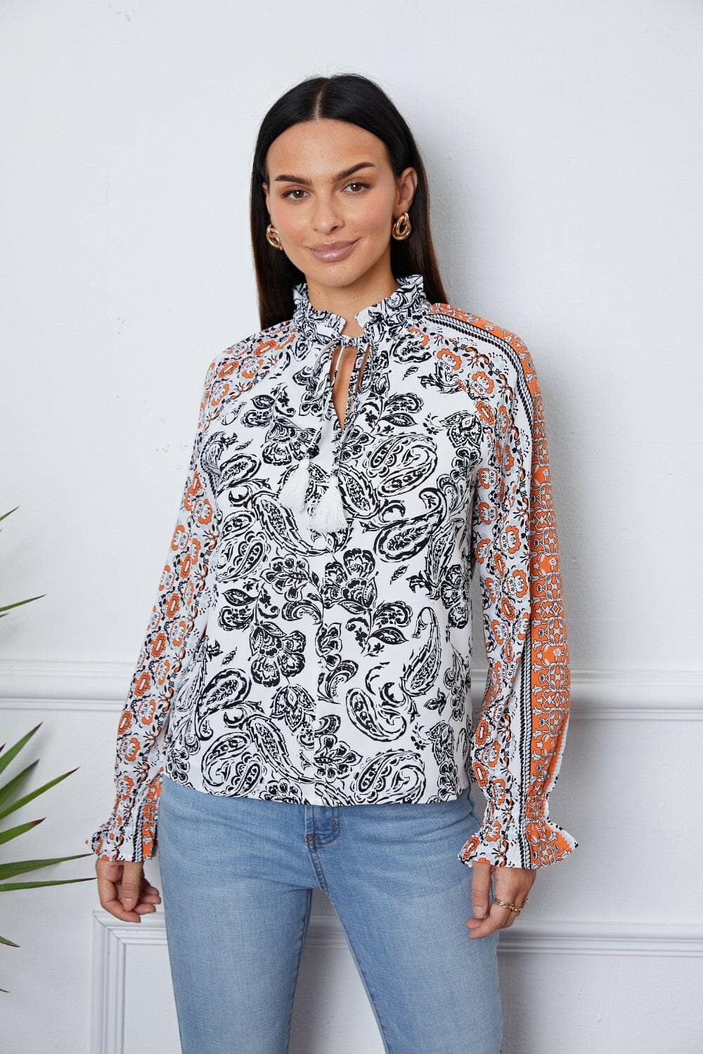 Tassel Tie Neck Printed Smocked Long Sleeve Blouse.