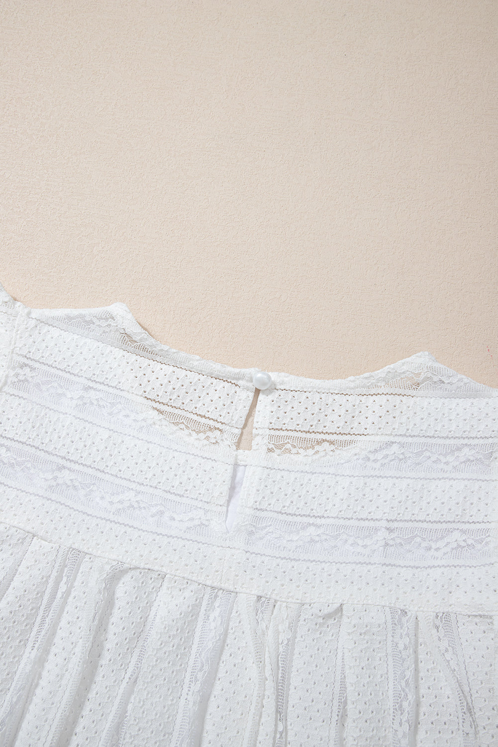 Lace-trimmed white flowy tank top with ruffled accents