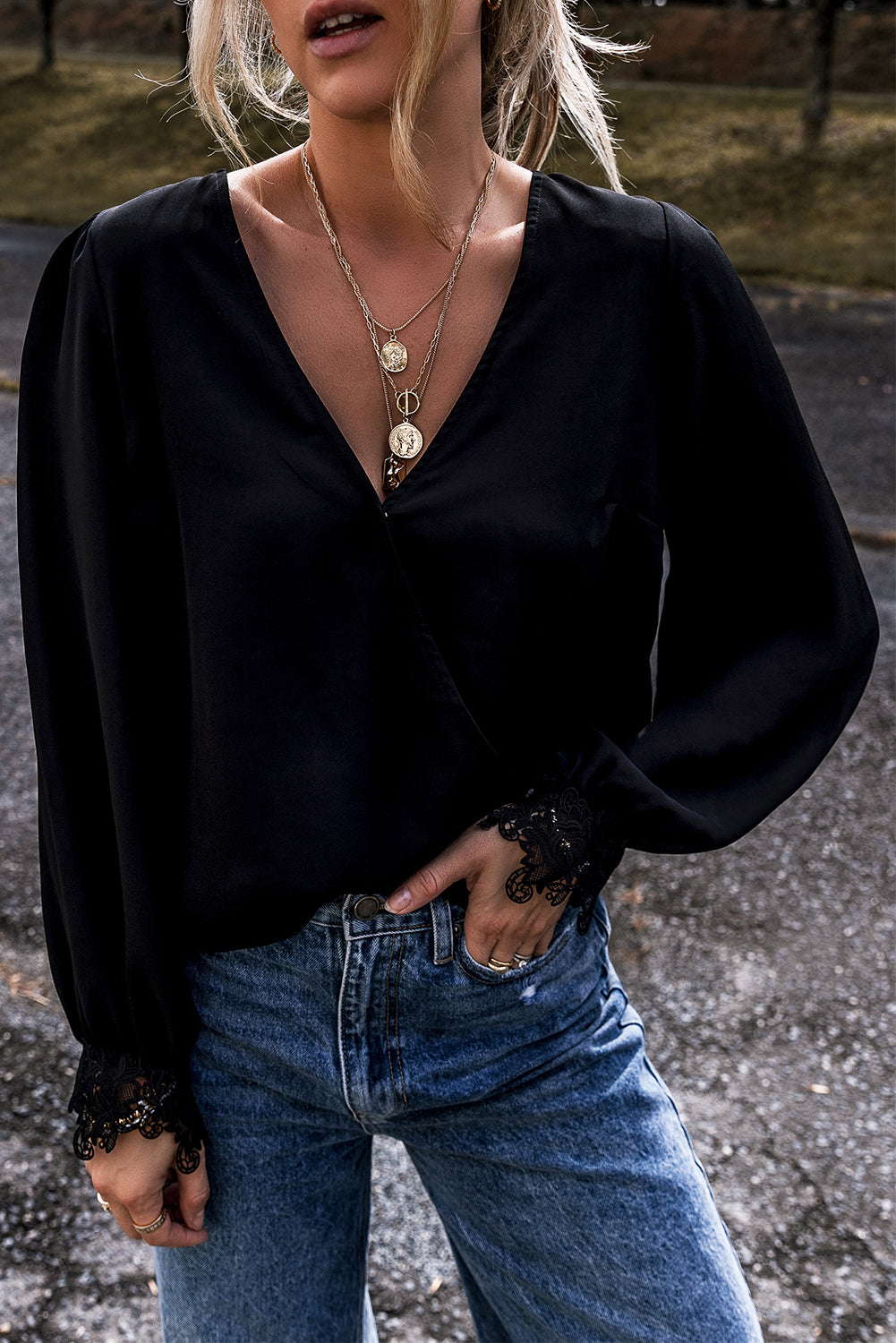 Elegant black lace V-neck blouse with crochet cuffs