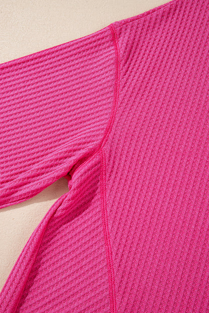 Chic bright pink waffle knit V-neck blouse with drop shoulders