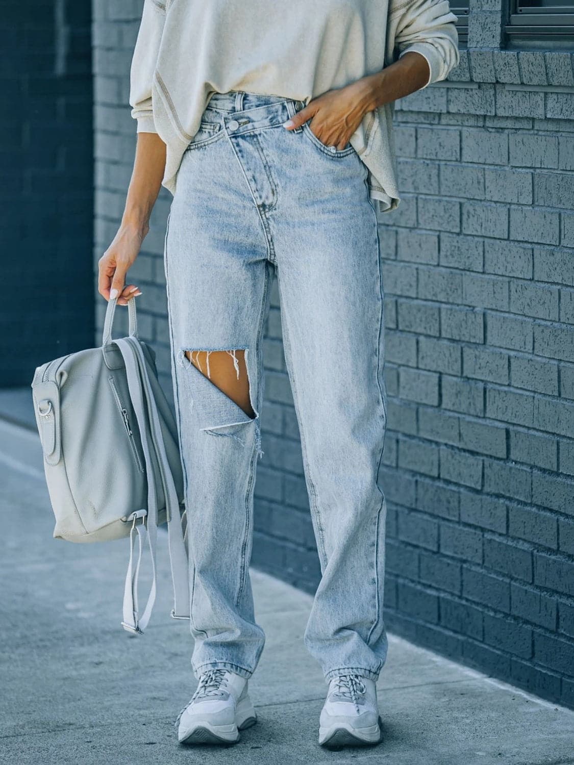 Distressed Asymmetric Waist Jeans.