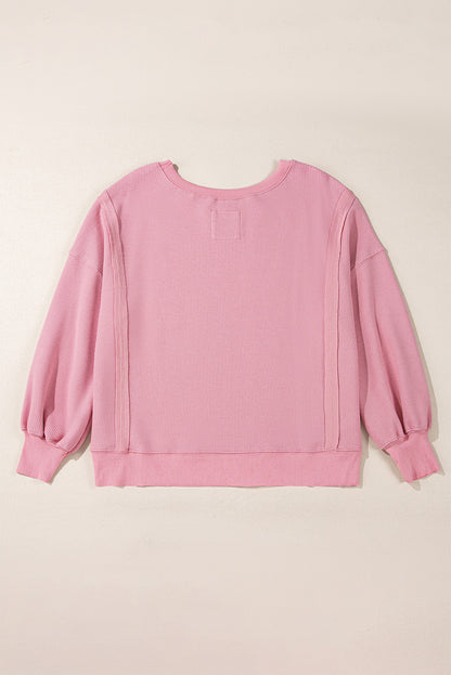 Cozy pink oversized sweatshirt with bishop sleeves and split detail