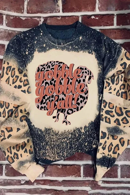 Leopard round neck long sleeve sweatshirt with 'gobble gobble y'all' design on a brick background.