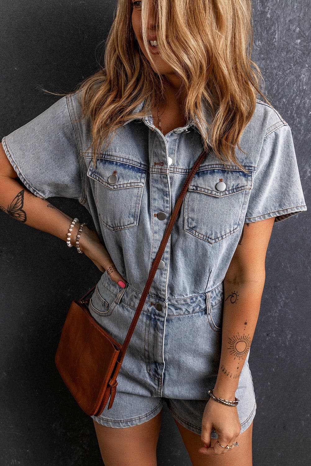 Chic denim collared neck short sleeve romper, sizes S-XL, stylish design.