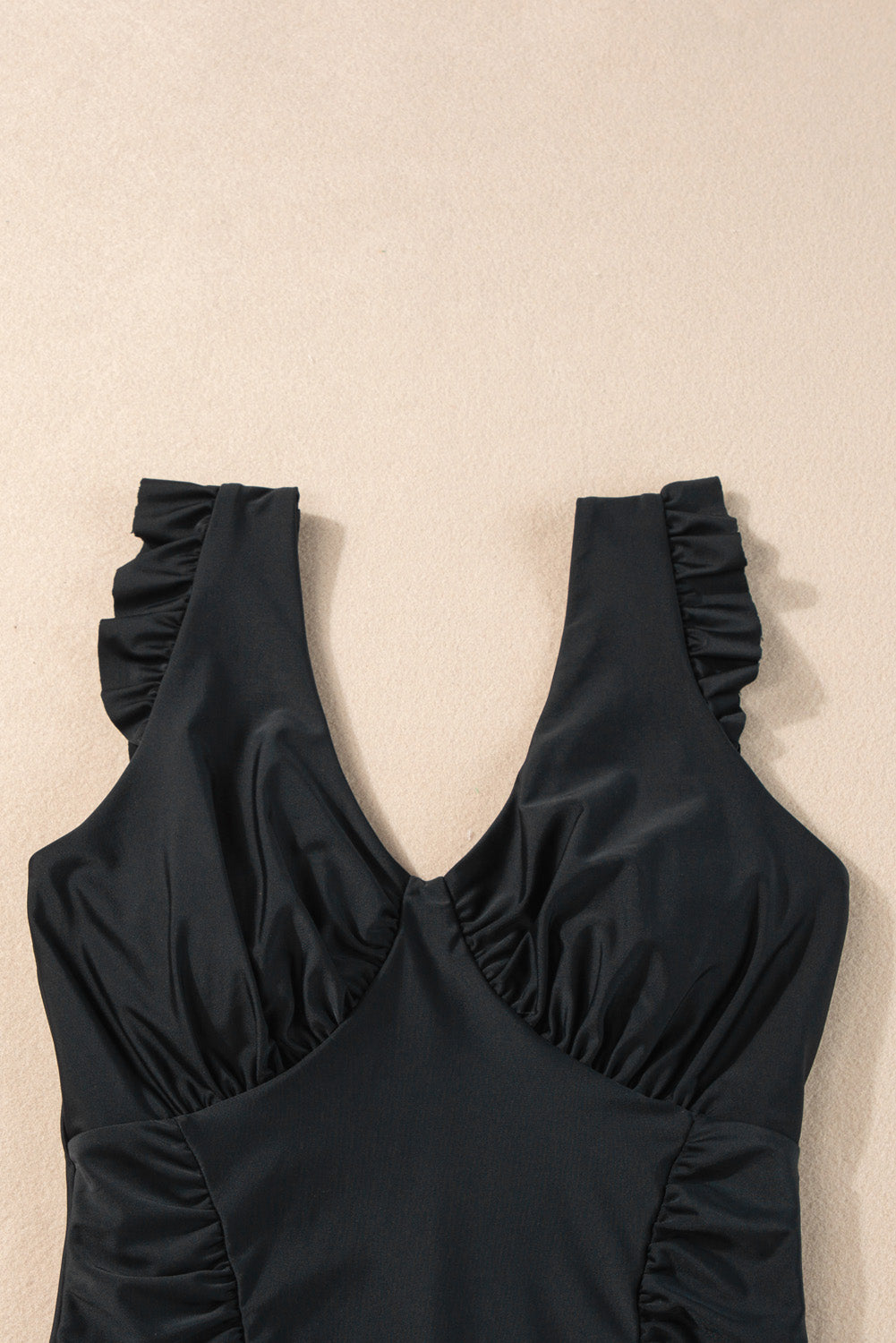 Chic black ruffled one-piece swimsuit with ruched details