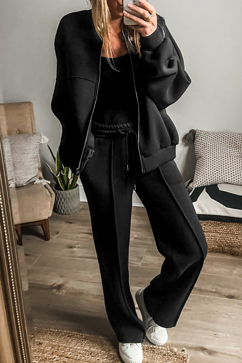 Chic black seamed zip jacket and drawstring waist pants ensemble